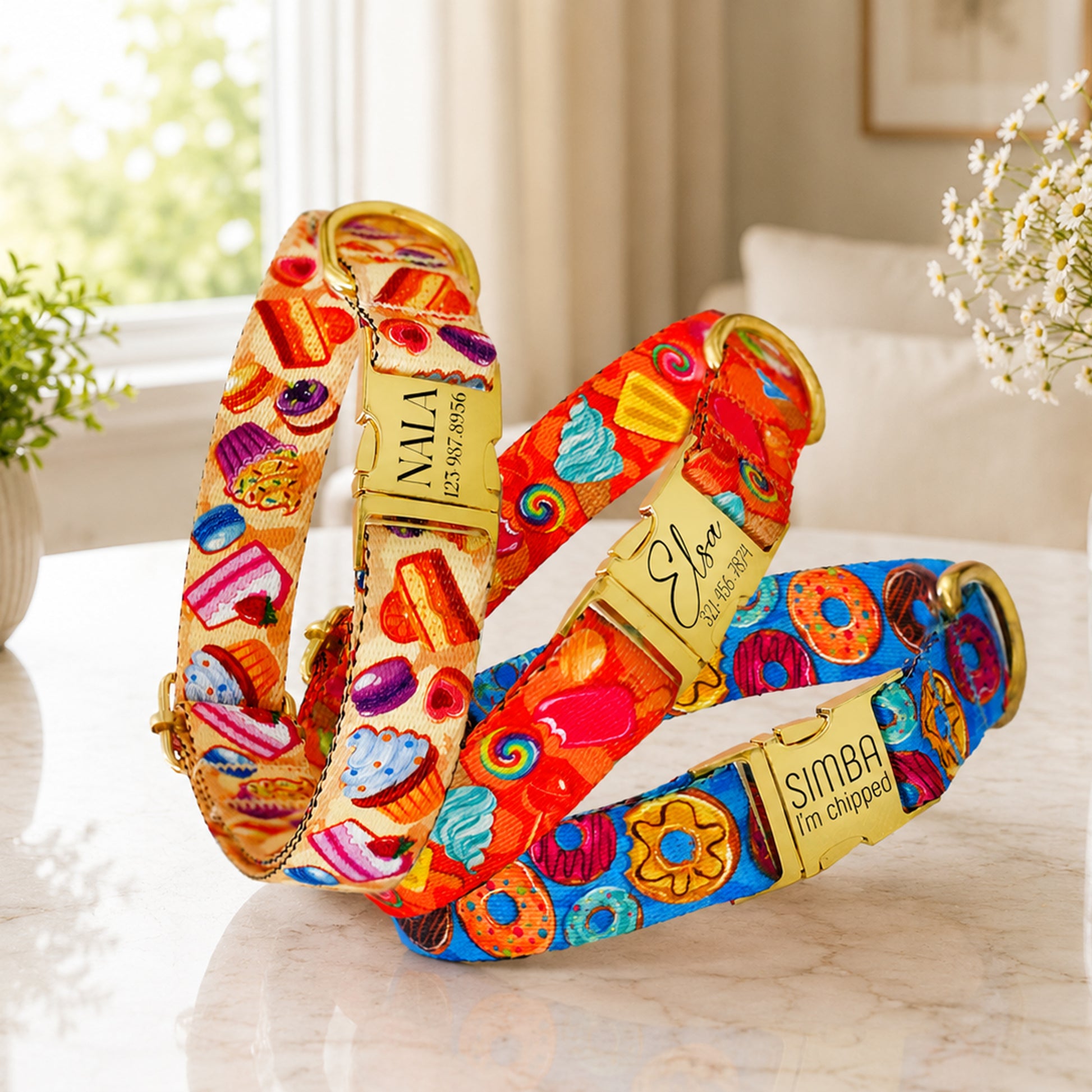 Colorful dog collar with cartoon character design on a soft surface.