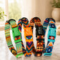Colorful patterned dog collars with engraved names on a light surface.