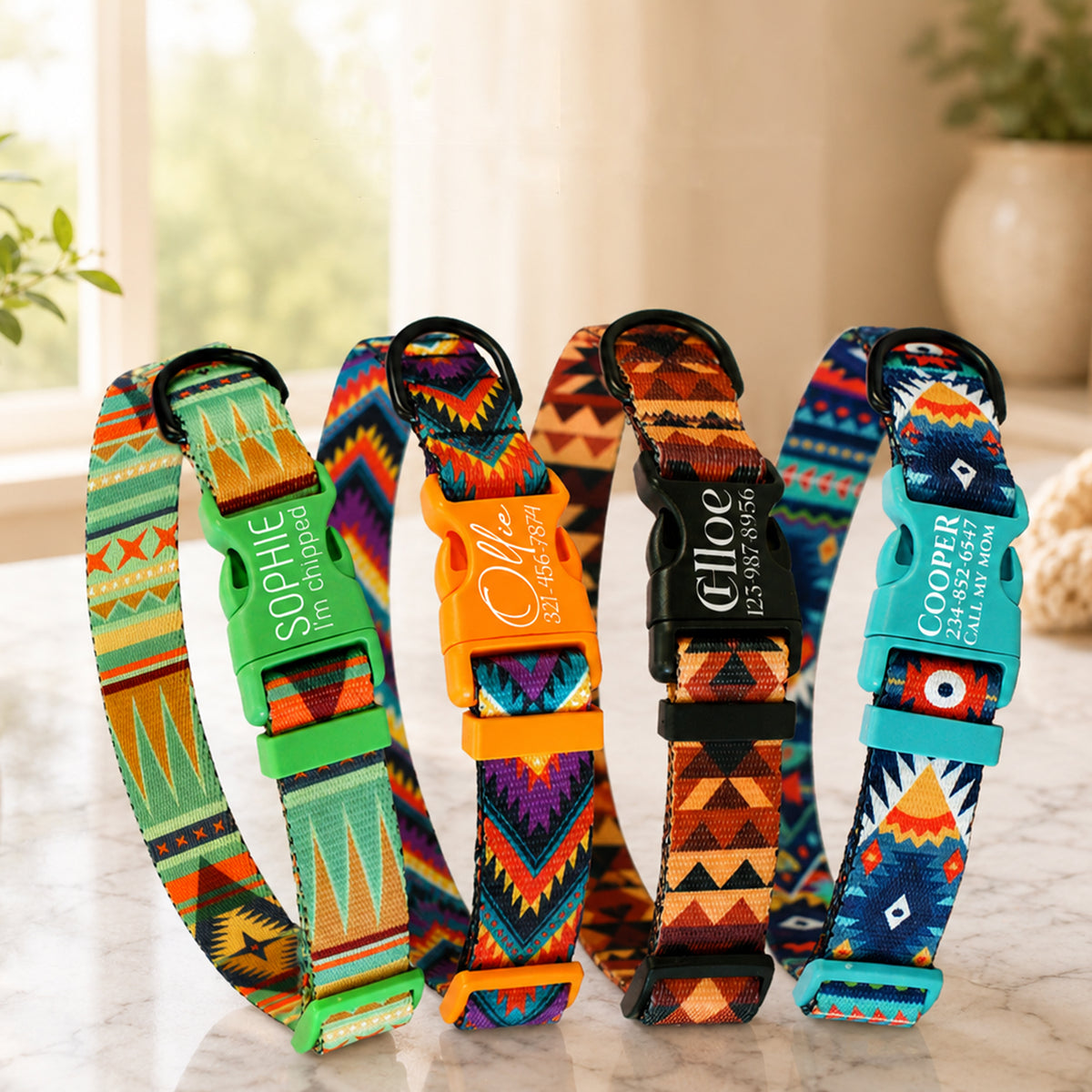 Colorful patterned dog collars with engraved names on a light surface.