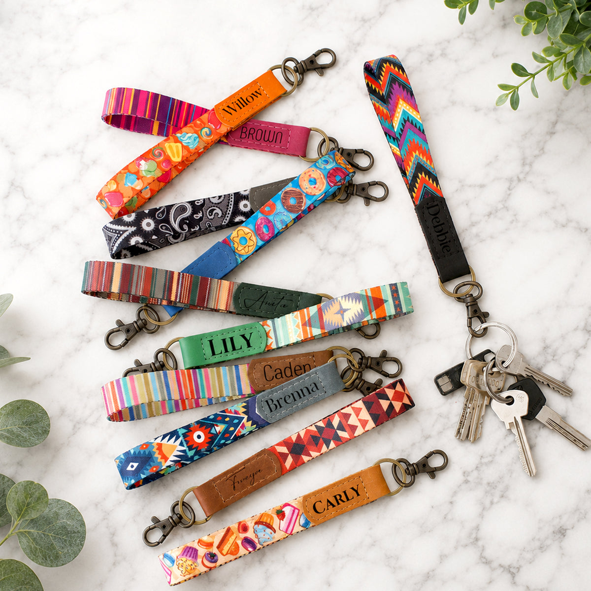 Colorful keychains with names on a marble surface