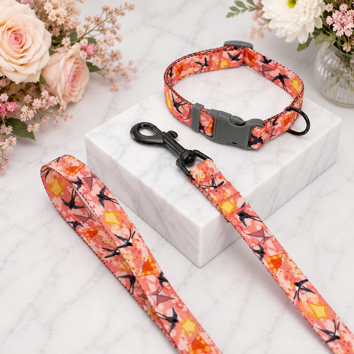 Floral dog collar and leash set on a white box with flowers in the background