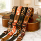 Set of colorful guitar straps with brand names on a guitar