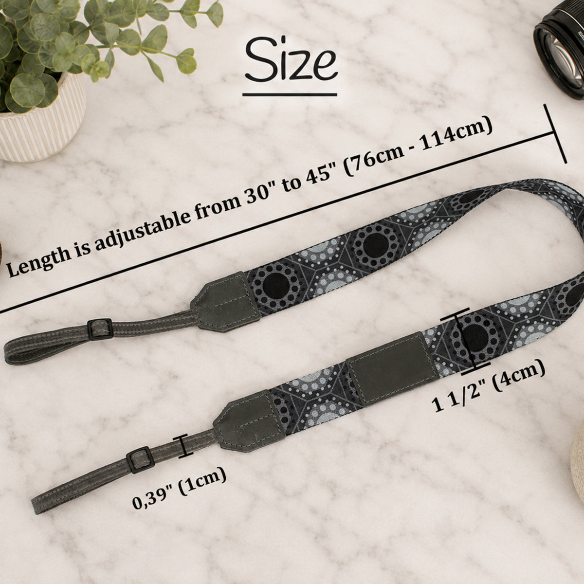 Camera strap with measurements on a marble surface