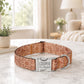Dog collar with 'Cooper I'm chipped' tag on a marble surface