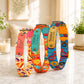 Colorful dog collars with various patterns on a marble surface.