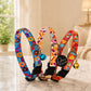 Colorful dog collars with bells on a marble surface