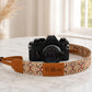 Camera with a patterned strap labeled 'Willow' on a marble surface.