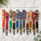 Colorful patterned keychains with names on a marble surface