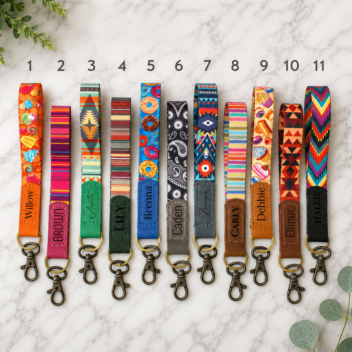 Colorful patterned keychains with names on a marble surface