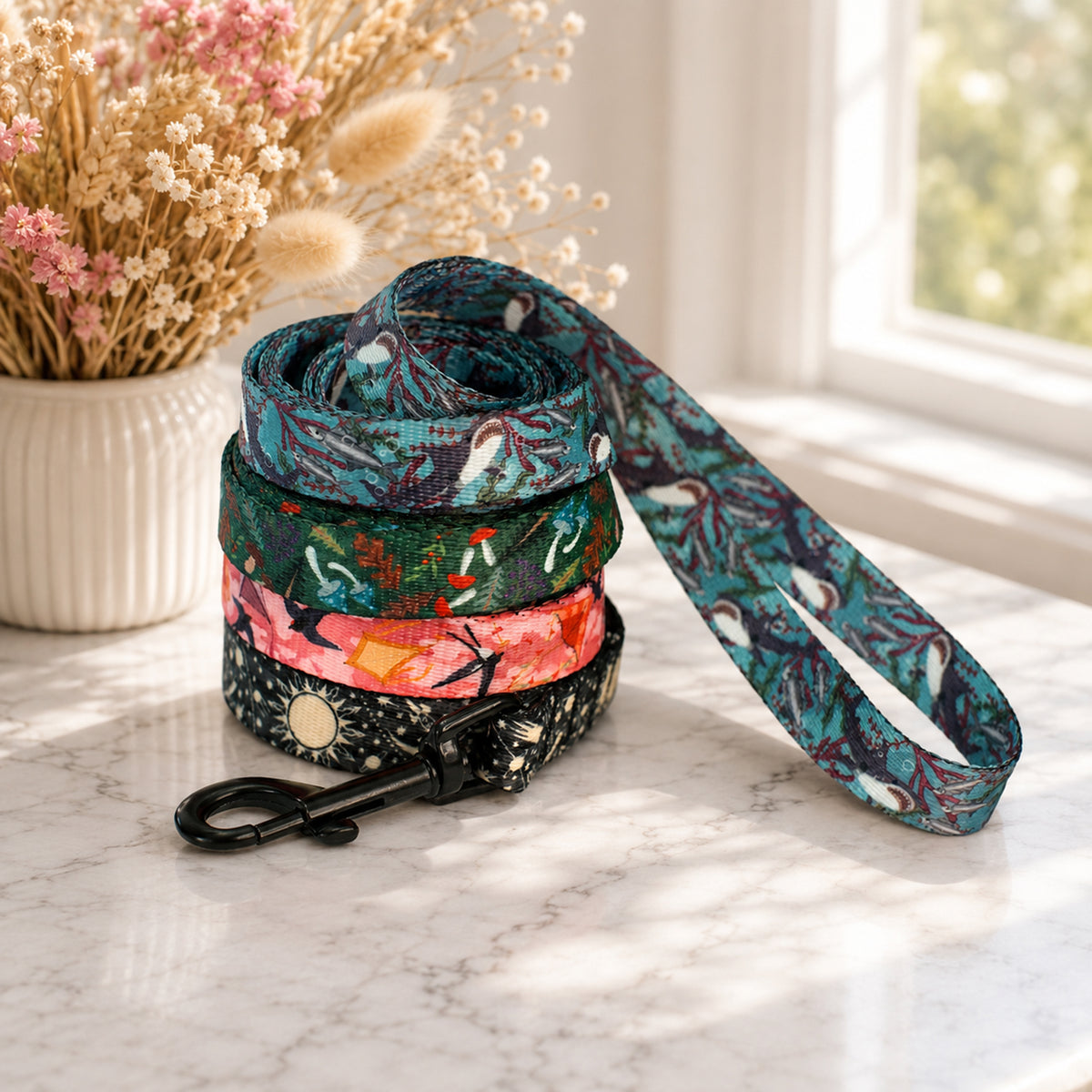 Floral-patterned dog leash with a matching collar on a marble surface with decorative elements.