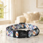 Plaid patterned dog collar with a black buckle on a marble surface.