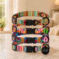 Colorful dog collars with patterned design on a marble surface.