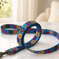 Colorful dog leash with donut pattern on a white surface
