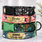 Stack of colorful dog collars with engraved names and phone numbers on a light background