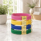 Stack of colorful dog collars with engraved names on a marble surface.