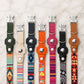 Collection of colorful dog collars with brand names on a marble surface