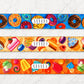 Three colorful belt straps with dessert-themed designs on a white background.