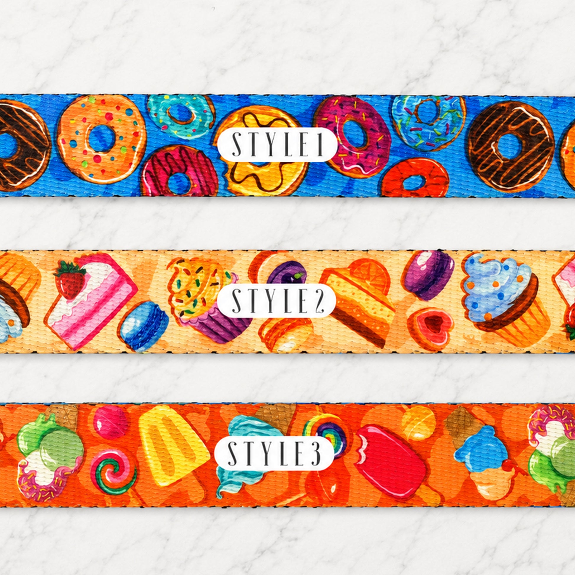Three colorful belt straps with dessert-themed designs on a white background.