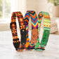 Three colorful dog collars with patterned designs on a marble surface.