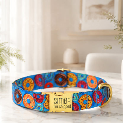Colorful dog collar with 'Simba I'm Chipped' tag on a marble surface.
