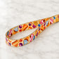Colorful fabric belt with dessert pattern on a marble surface
