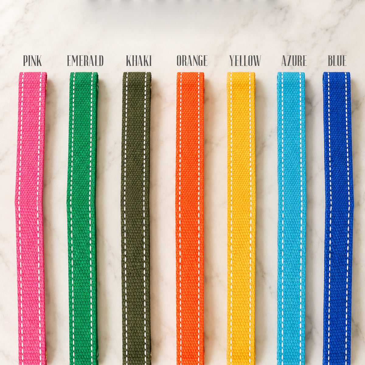 Set of colorful woven straps on a marble surface