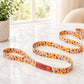 Colorful dog leash with a nameplate on a light surface