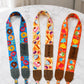 Three colorful fabric straps with different patterns on a marble surface.