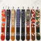 Eight colorful guitar straps with different patterns and names on a light gray background