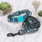 Patterned dog collar and leash on a marble surface with decorative plants.