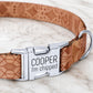 Dog collar with engraved metal tag on a marble surface