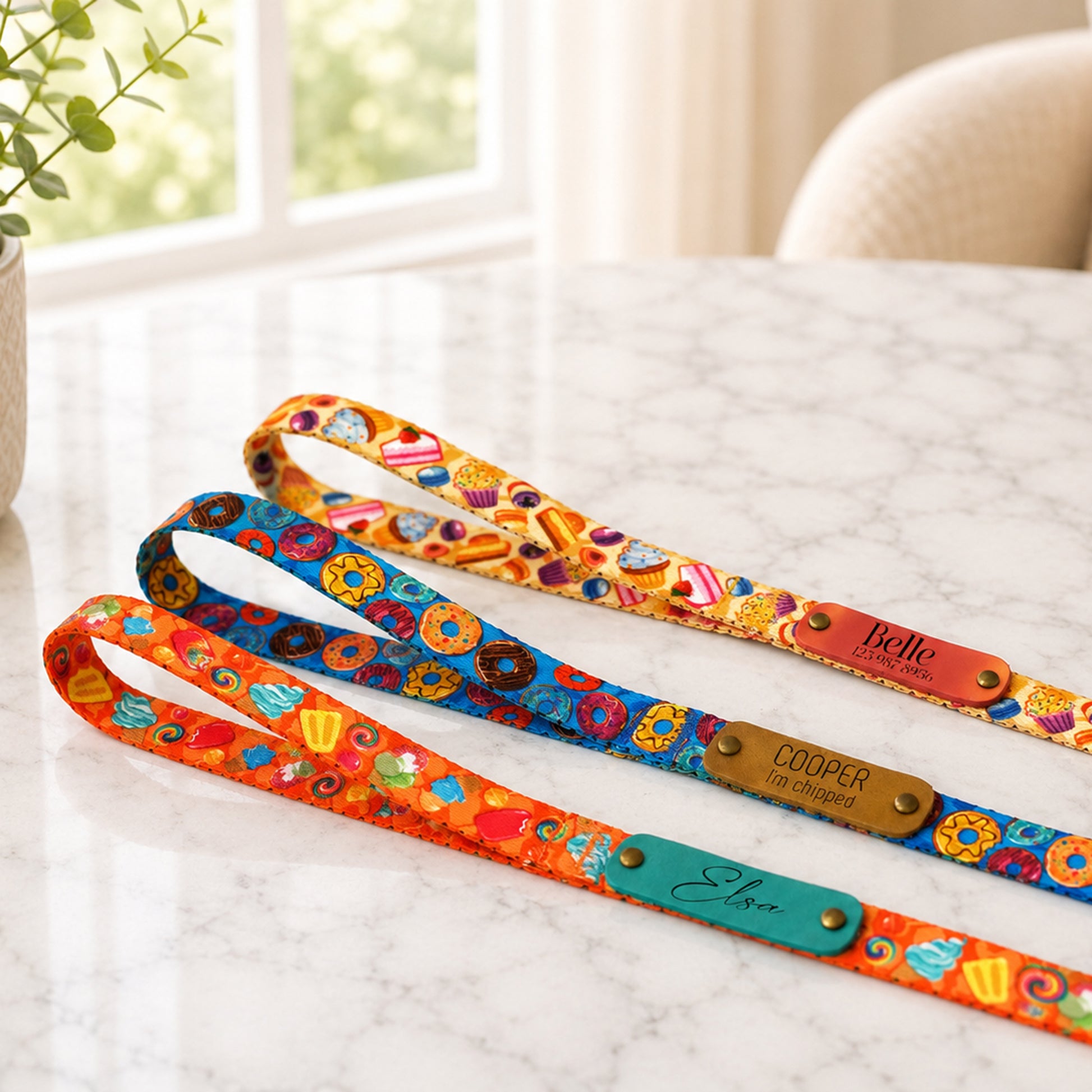 Colorful dog leashes with names on a marble surface