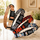Collection of patterned dog collars with names and phone numbers on a blurred indoor background
