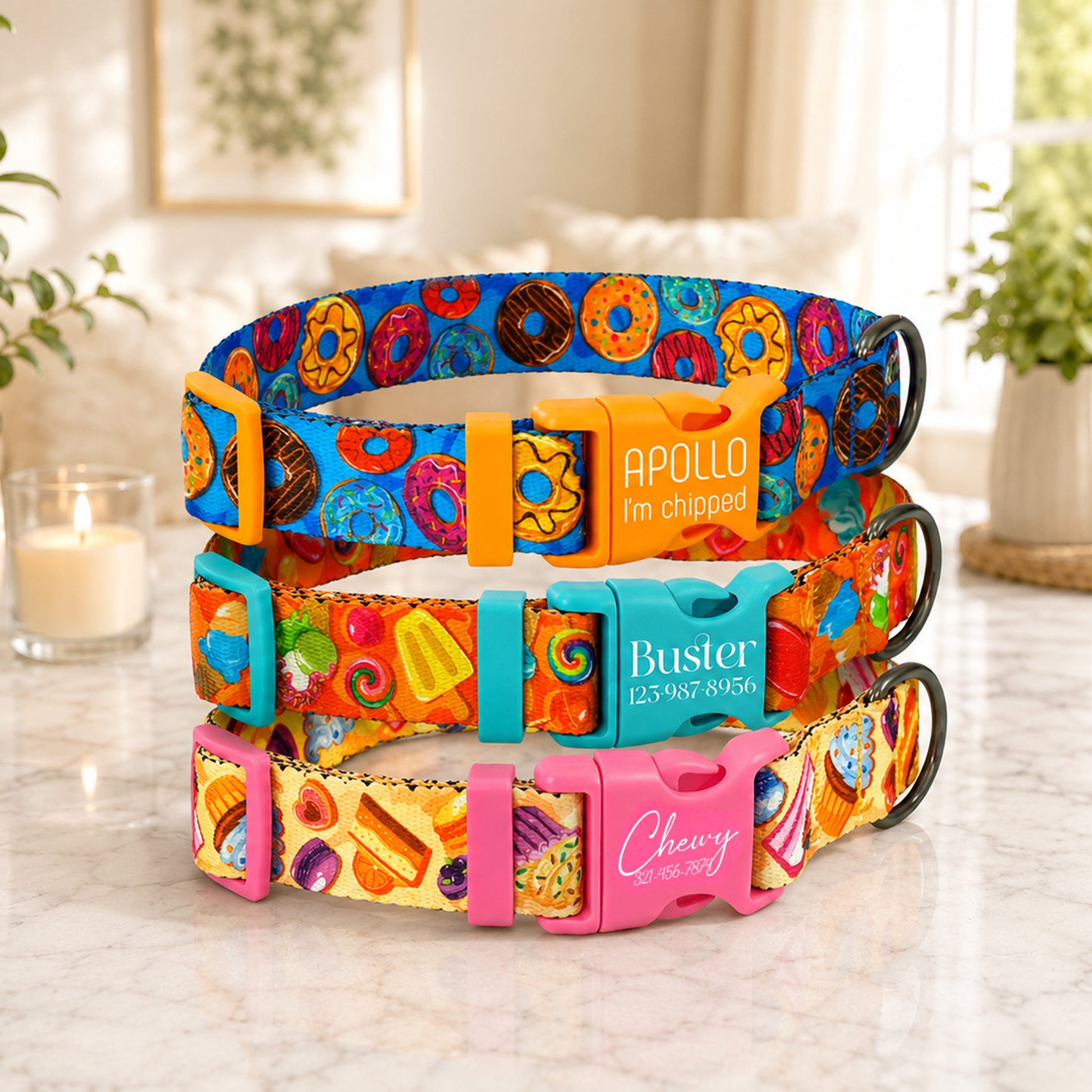 Colorful dog collars with personalized names on a marble surface.