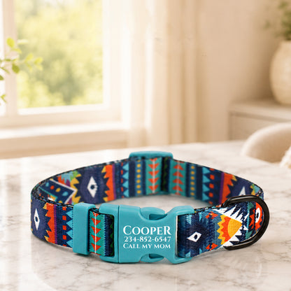 Colorful patterned dog collar with engraved text on a marble surface