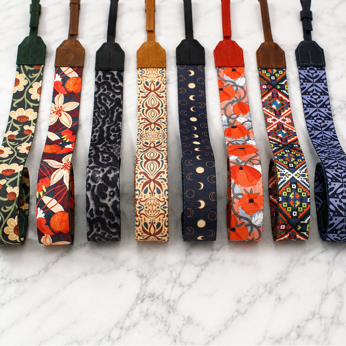 Collection of colorful patterned straps on a marble surface