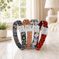 Five dog collars with different patterns and colors on a light surface.