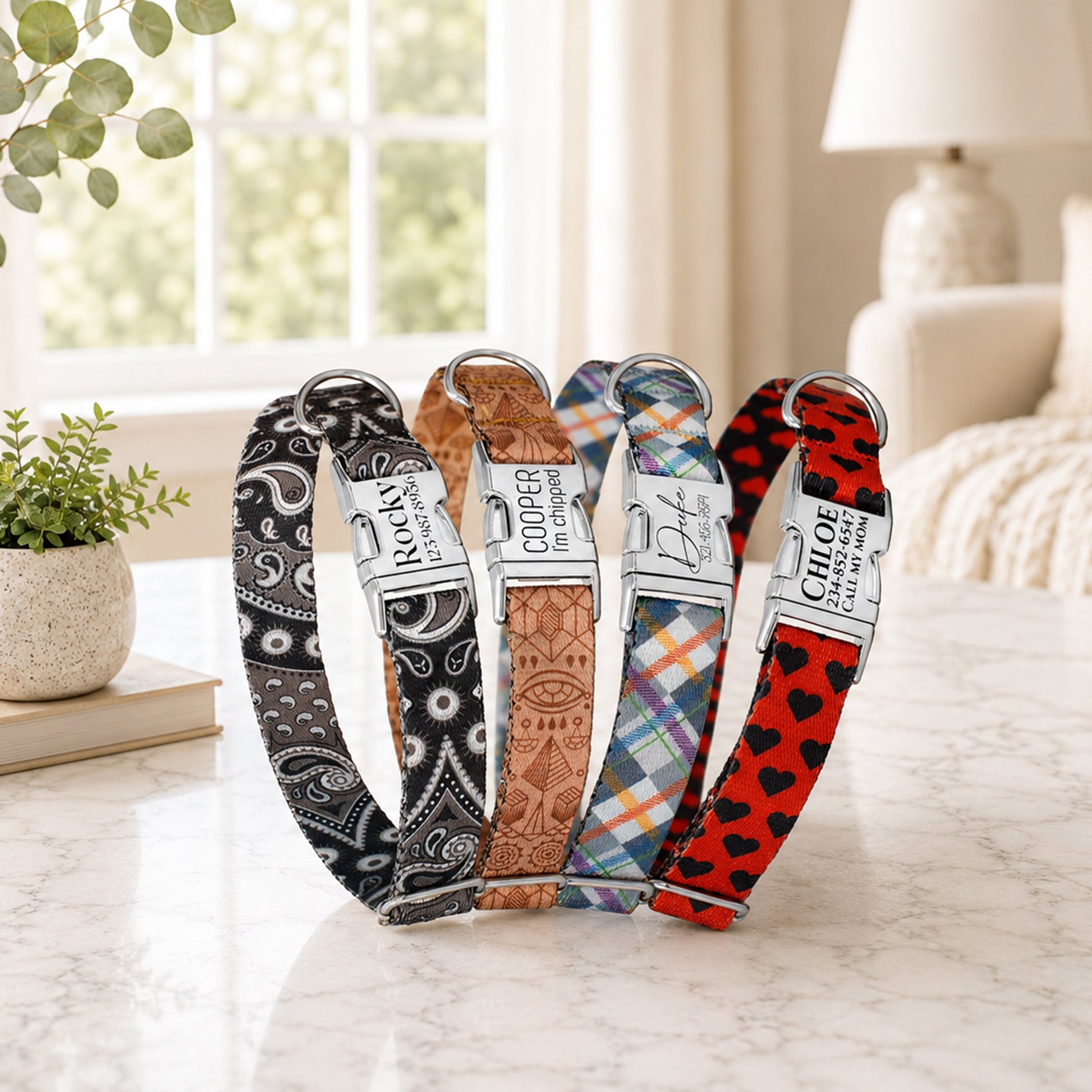 Five dog collars with different patterns and colors on a light surface.