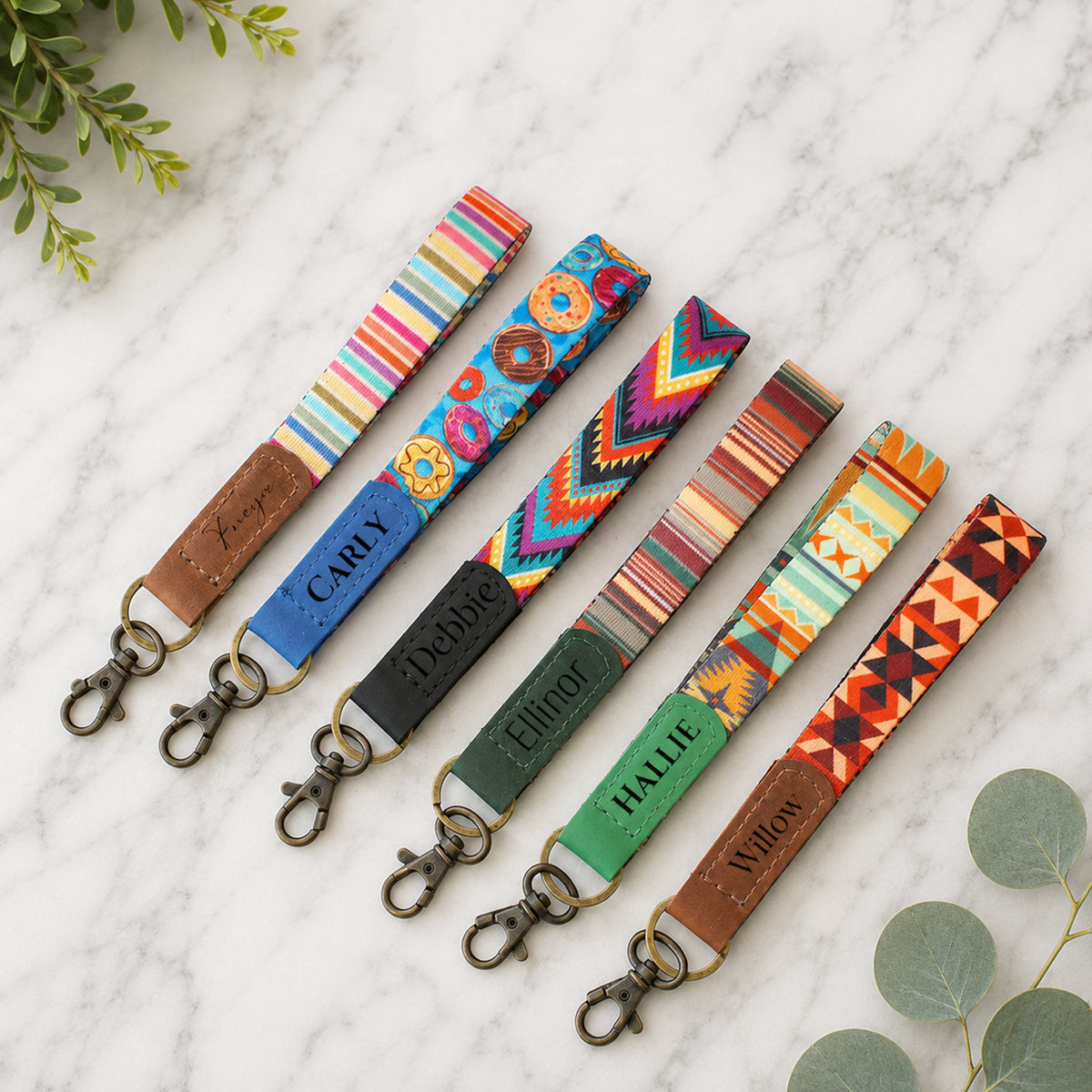 Colorful patterned lanyards with name tags on a marble surface.