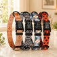Five patterned pet collars with engraved names on a marble surface.